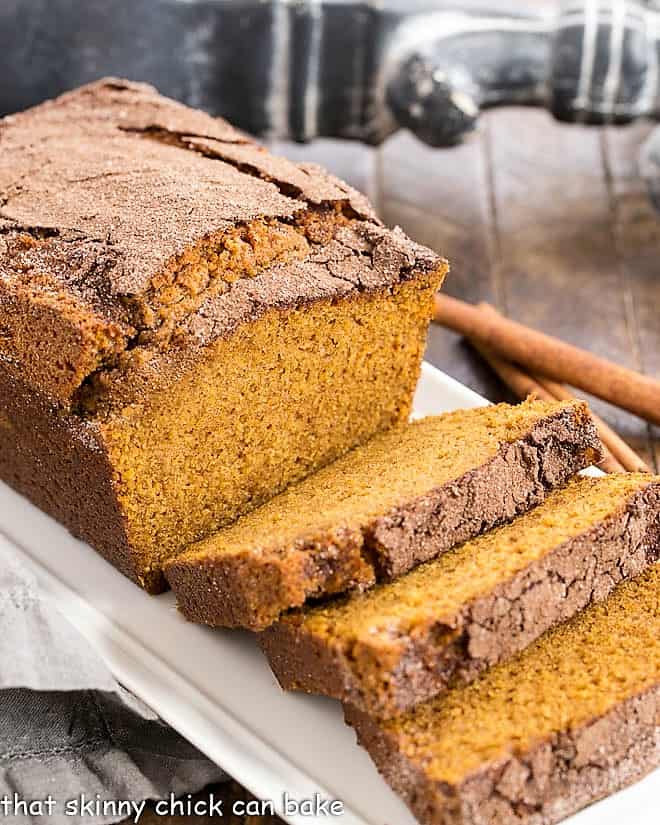 A partially sliced loaf of a pumpkin bread recipe.