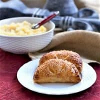 Compote de Pommes or French Applesauce in a bowl and as filling in two apple turnovers