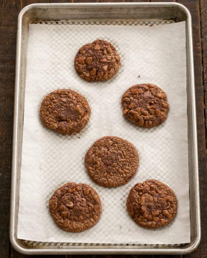 Baked double chocolate cookies on a baking sheet.