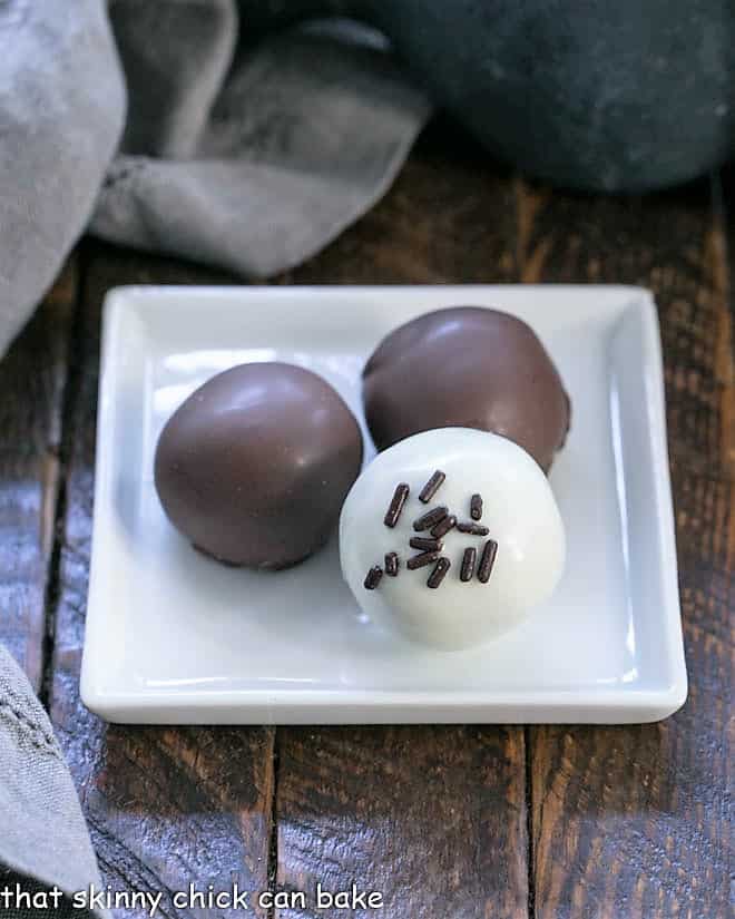 3 Oreo truffles on a square white plate