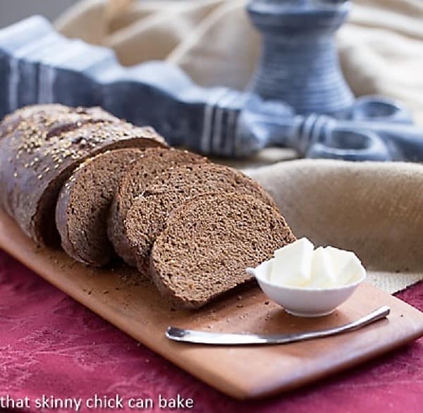 Sliced pumpernickel loaves on a cutting board