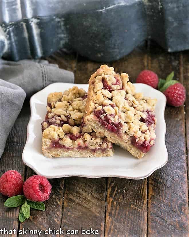 2 raspberry Oatmeal Bars on a white dessert plate