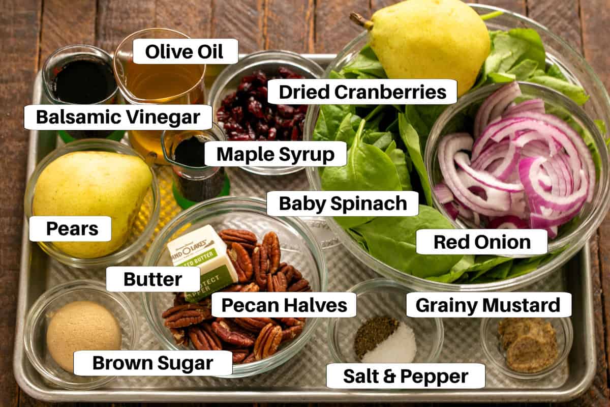 Spinach Salad with pears ingredients with labels on a metal sheet pan.