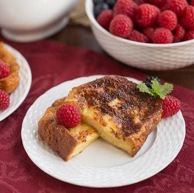 Sugar crusted French toast halves on a white plate