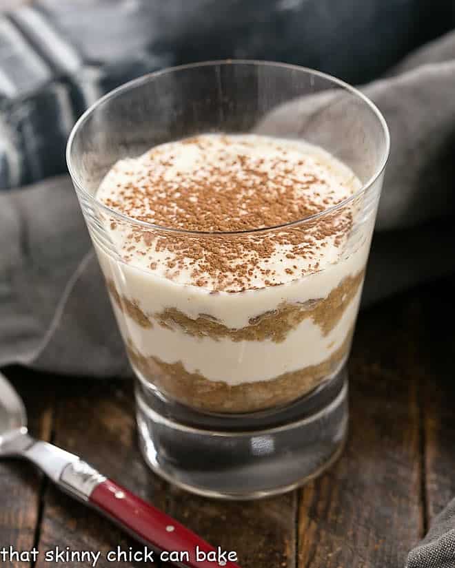 Tiramisu Parfait in a glass with a red handled spoon.