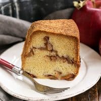 Cinnamon Apple Bundt cake slice on a round white plate with a fork