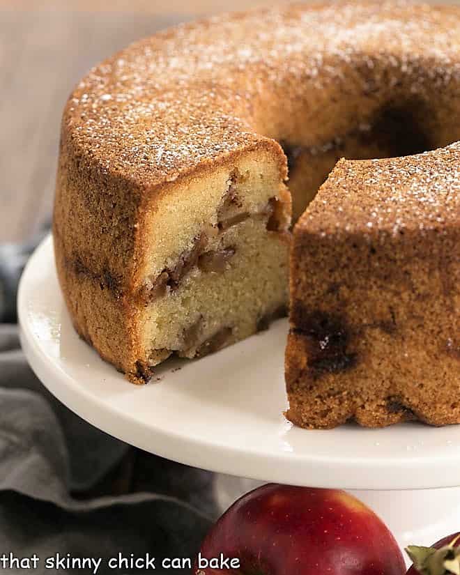 Cinnamon Apple Bundt Cake on a white cake stand.