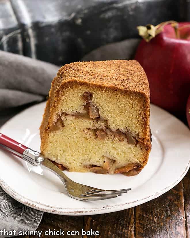 Cinnamon Apple Bundt cake slice on a round white plate with a fork.