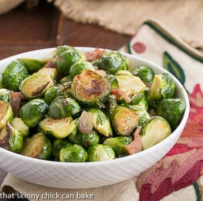 Brussels Sprouts with Bacon, Shallots and Garlic in a white serving bowl