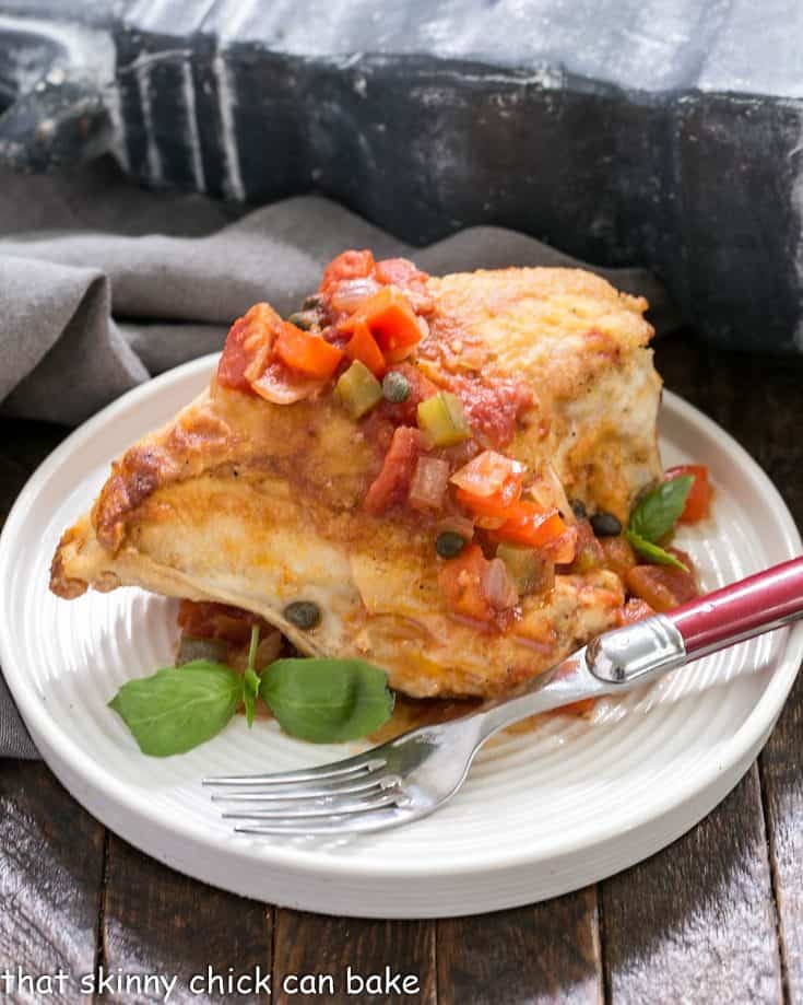 Chicken Cacciatore on a white plate with a red handle fork.