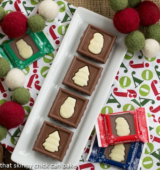 Festive Fudge Snowflakes and Squares on a white ceramic tray.