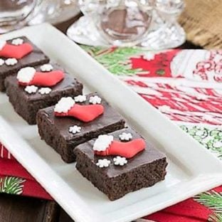 Fudgy red wine brownies with Christmas sprinkles on a white tray