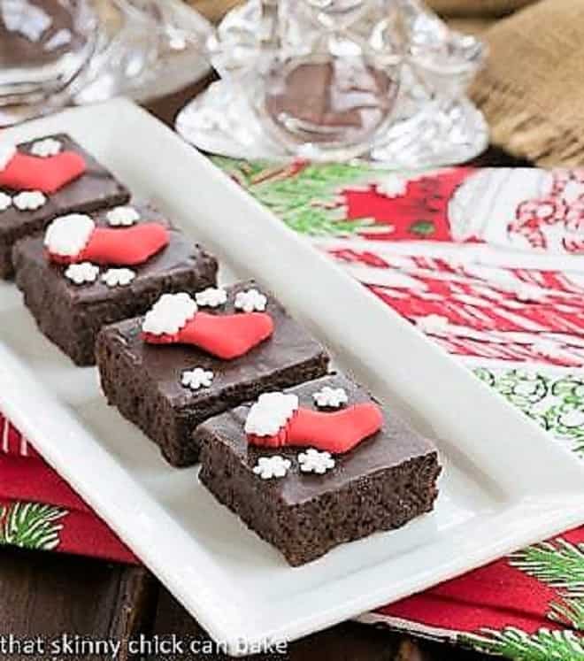 Fudgy red wine brownies with Christmas sprinkles on a white tray