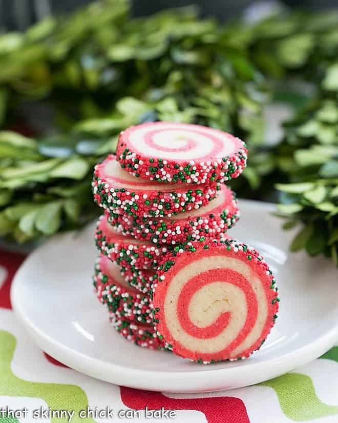 Holiday Pinwheel Cookies stacked on a small round white plate