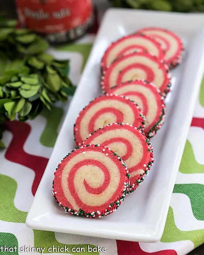 Holiday Pinwheel Cookies on a narrow white ceramic tray.