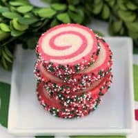 Holiday Pinwheel Cookies stacked on a square white plate