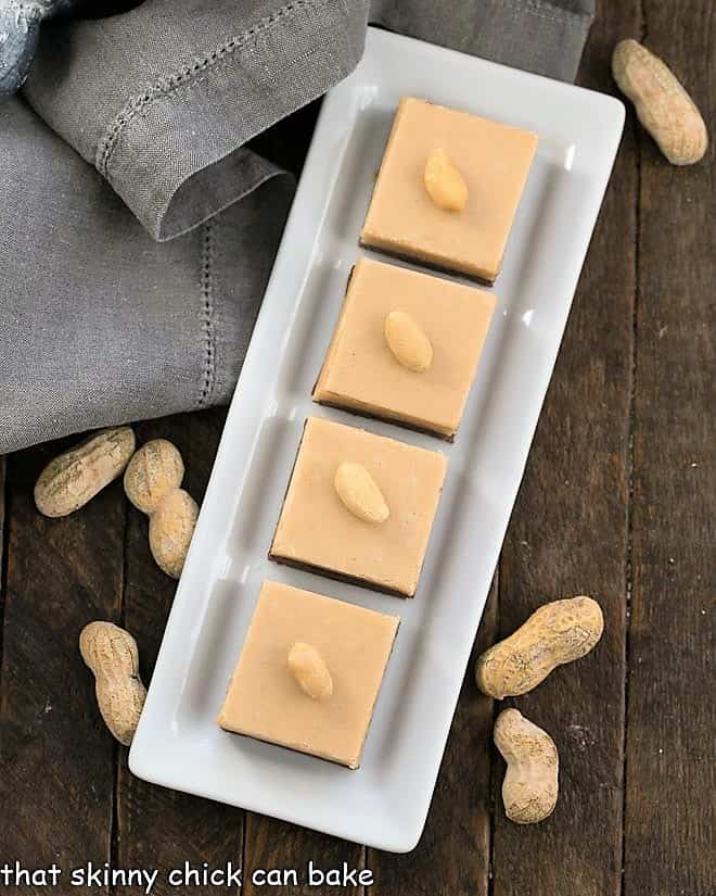 Overhead view of layered chocolate peanut butter fudge on a white tray.