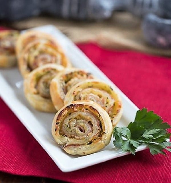 Prosciutto, Gruyere and Basil Pinwheels - an easy, elegant puff pastry appetizer that's a breeze to prepare Prosciutto, Gruyere and Basil Pinwheels on a white tray