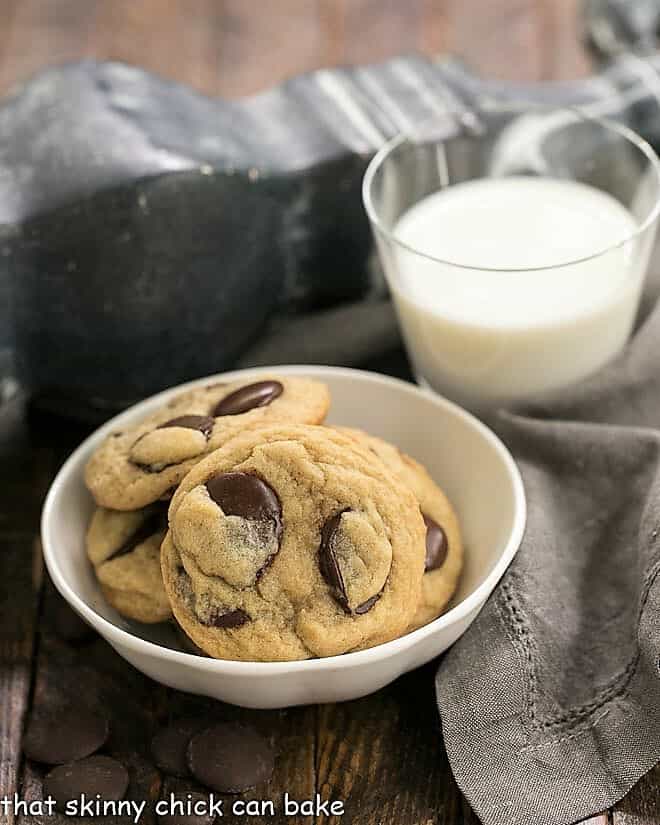 Southern Living's BEST Chocolate Chip Cookies in a white bowl next to a glass of milk