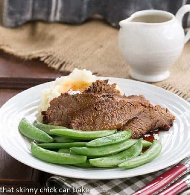 Coffee Blazed Brisket slices on a white dinner plate.