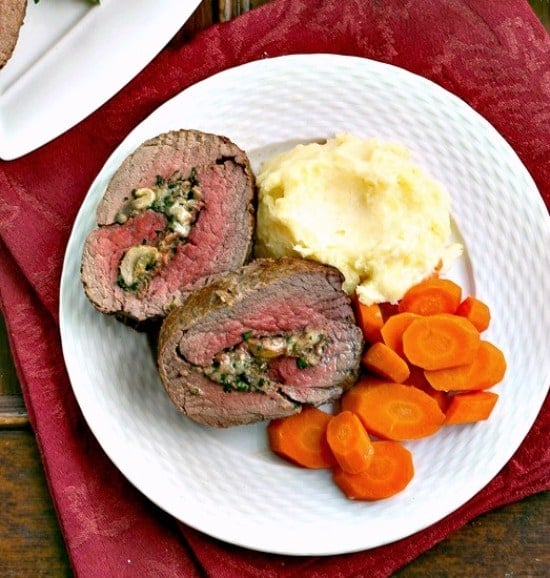 Slices of Gorgonzola and Mushroom Stuffed Beef Tenderloin on a dinner plate