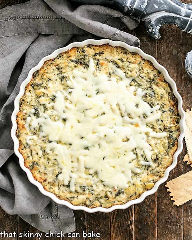 Overhead view of spinach dip in a round white dish.