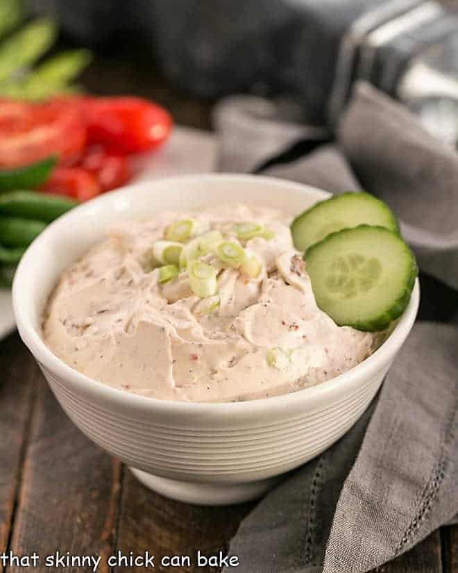 Sun-dried Tomato Dip with garnish of green onions and cucumbers.