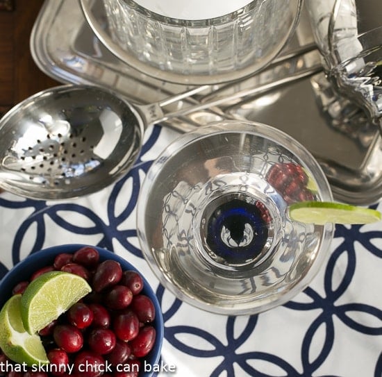 White Cosmopolitans from above with a bowl of garnishes.