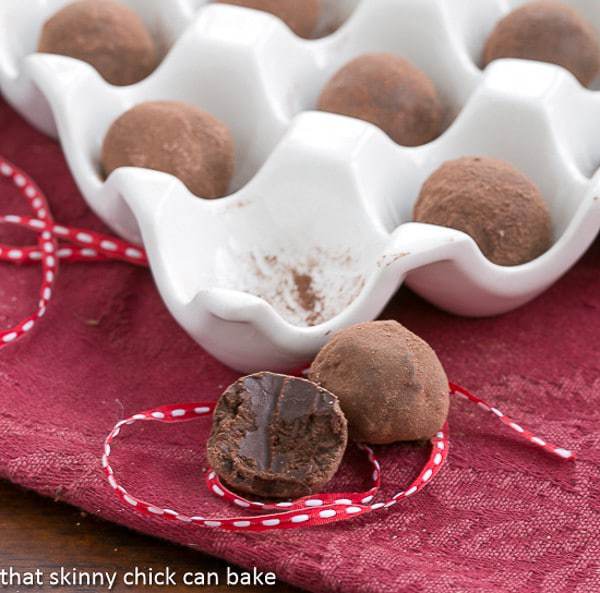 Chocolate Balsamic Truffles in a egg carton tray and one in the foreground with a bite removed