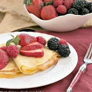 Butter and Rum Crêpes filled with lemon curd and topped with fresh berries