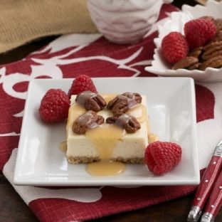 Caramel Pecan Cheesecake Bars - With a pecan, vanilla wafer crust, cheesecake topping and pecan and caramel garnish, this sublime dessert is perfect for cheesecake fans!
