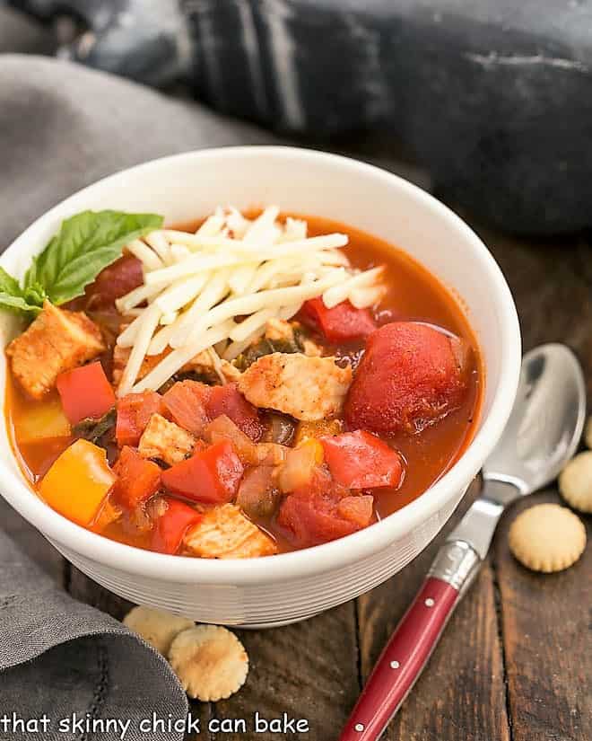 Chicken and Bell Pepper Chili - This unusual, pepper filled chicken chili is ALWAYS a hit! Perfect for game day or anytime you need a hearty, comforting, warming meal. Chicken and Bell Pepper Chili in a white bowl.