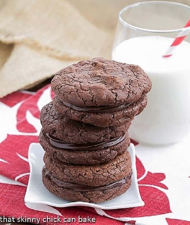 Stack of chocolate sandwich cookies on a small white plate