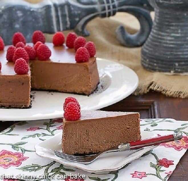 Chocolate-Mascarpone Cheesecake slice on a white cake plate with a fork