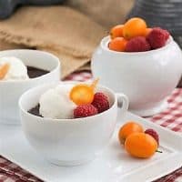 Chocolate Pots de Crème for Two on a white tray topped with whipped cream and fruit