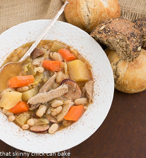 French Garbure Stew overhead shot with dinner rolls.