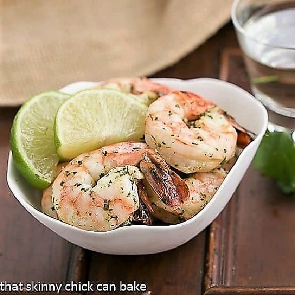 Margarita shrimp in a bowl with lime slices.