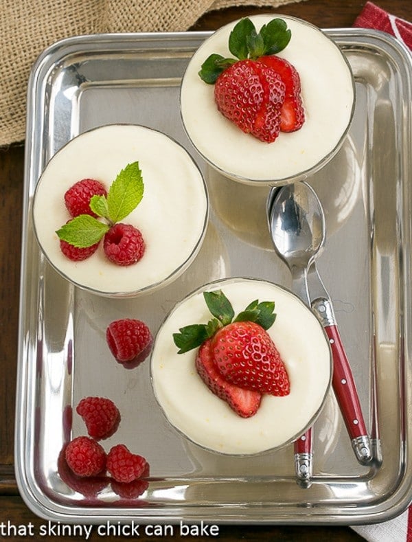 Dreamy White Chocolate Mousse Recipe spiked with Frangelico in glass parfait dishes on a silver tray.