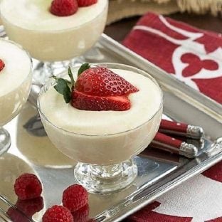 Dreamy White Chocolate Mousse spiked with Frangelico in glass dishes topped with berries