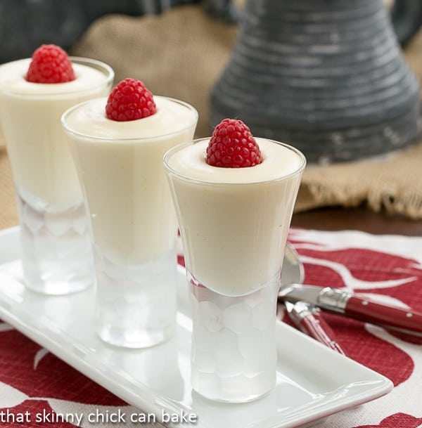 Dreamy White Chocolate Mousse spiked with Frangelico in decorative shot glasses topped with raspberries.