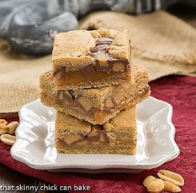 Chocolate Peanut Butter Bars stacked on a white plate.