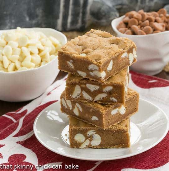 Butterscotch Blondies with White Chocolate Chips stacked on a white plate