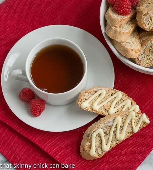 Overhead view of two Cantuciini or Almond Biscotti next to a cup of tea