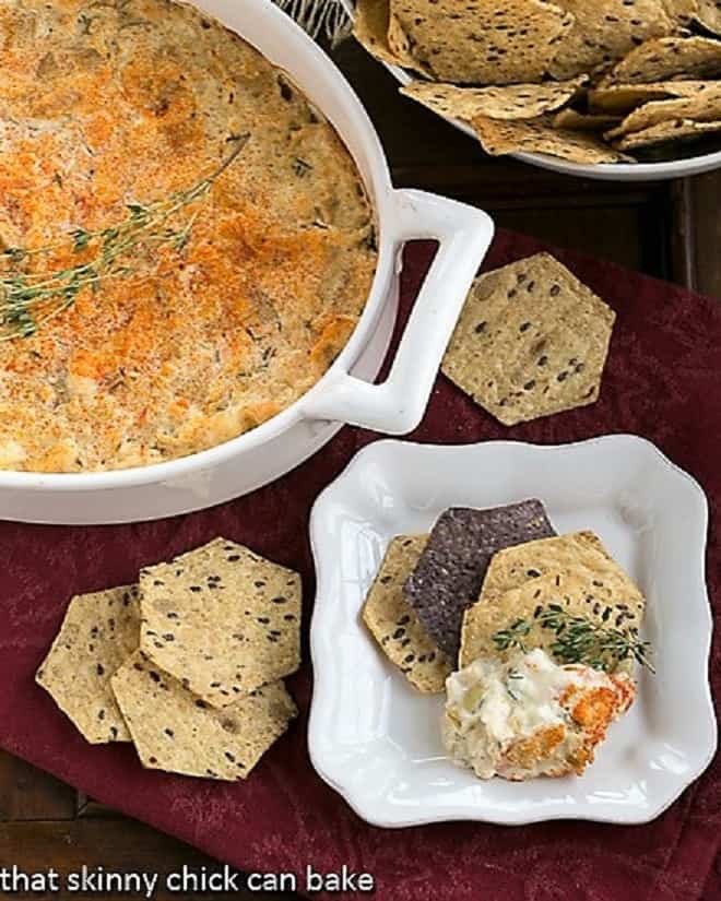 Overhead view of Hot Artichoke Shrimp Dip in a casserole and on a small plate.