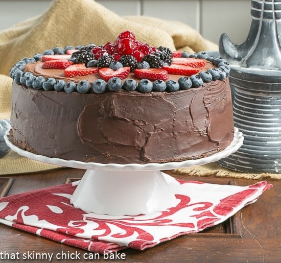 Layered Chocolate Mousse Cake on a white serving platter.