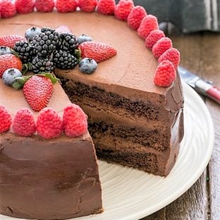 Layered chocolate mousse cake with a slice removed