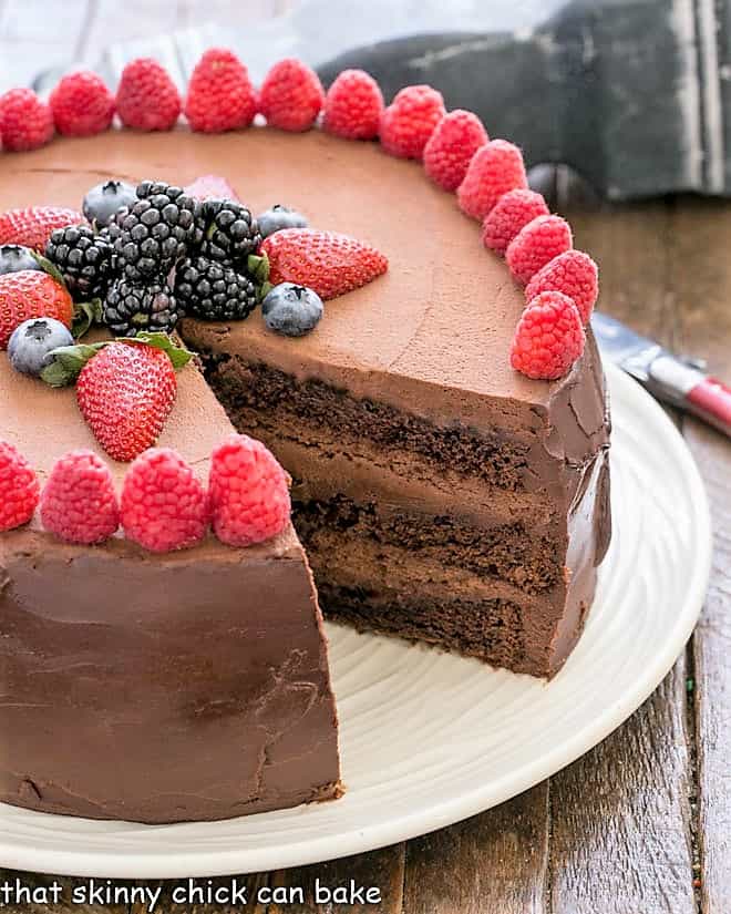 Layered chocolate mousse cake with a slice removed