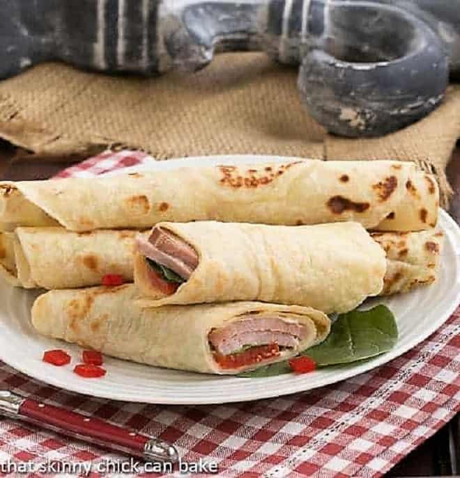 Potato Lefse sandwiches on a white serving plate.