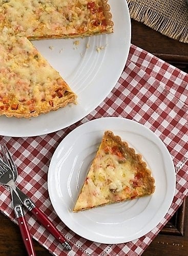 Quiche Maraichere slice removed from serving plate