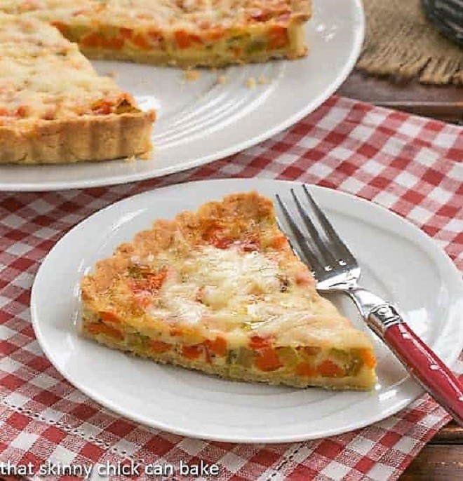 Quiche Maraîchère AKA Vegetable quiche on a white plate with a red handled fork